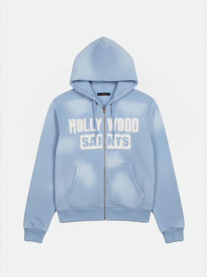 Hollywood Saints sky blue sun fade zip up hoodie with white varsity logo, front view on clean background.