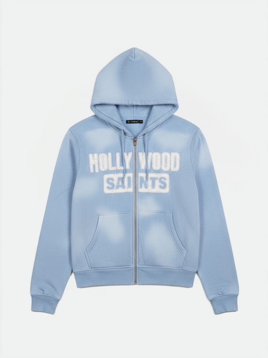Hollywood Saints sky blue sun fade zip up hoodie with white varsity logo, front view on clean background.